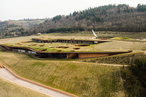 The Antinori Wine company whose vineyards surround the Badia di Passignano Monastry have recently carved this office building into the hillside alongside the Florence to Siena Autostrada. Notice the infant vines that have been planted on the "roofs" of the offices which will grow and produce wine in a few years time.